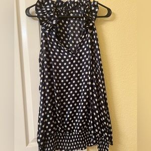 Sleeveless top with white dots.